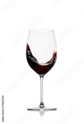 Red wine in a glass with splash isolated on white background photo
