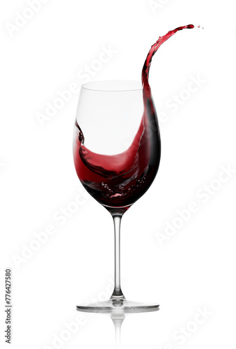 Red wine in a glass with splash isolated on white background photo