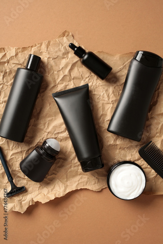 Set of black cosmetics bottles for men skin care on craft paper. Flatlay.