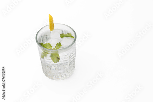 High-angle view of a cocktail with mint and ice in a glass, isolated on a white backdrop