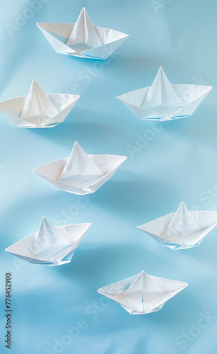 A series of paper boats arranged on a light blue-AI generated image 