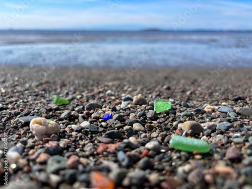 Seaglass in different colors among the pebbles on a beach along the Bay of Fundy, New Brunswick, Canada