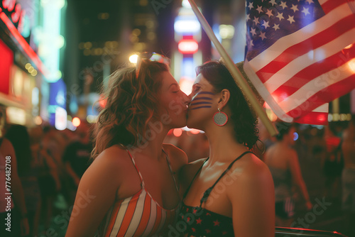 Two young women lesbians lgbt kissing with America Flag celebrating 4 July or NYC Pride Parade at New York City streets at summer  photo
