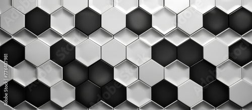 Close up shot of a wall made of black and white tiles arranged in a decorative pattern © AkuAku
