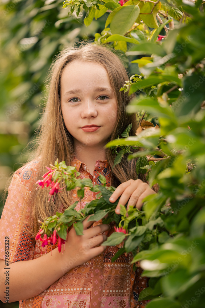 Portrait of pre-teen girl in lush garden setting Portrait of pre-teen girl in lush garden setting
