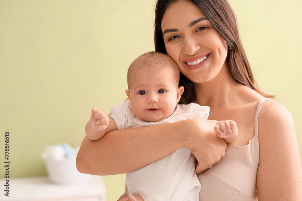 Happy mother with cute little baby in room at home Happy mother with cute little baby in room at home