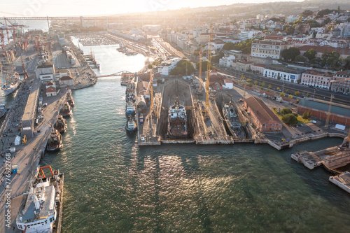 Aerial drone shot ship repair dry dock in Lisbon's port, situated on the north bank of the Tagus River. The shipyard is a key facility at the heart of Lisbon harbor. photo