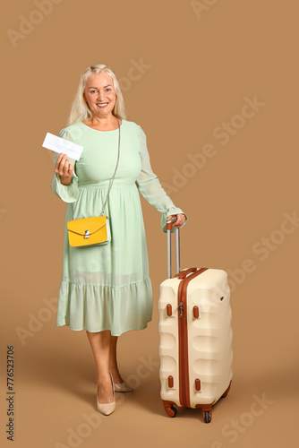 Senior woman with suitcase ...