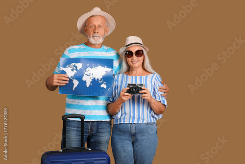 Senior couple with suitcase...