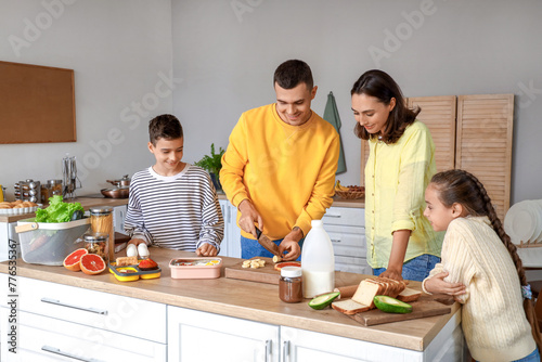 Happy family cooking in kit...