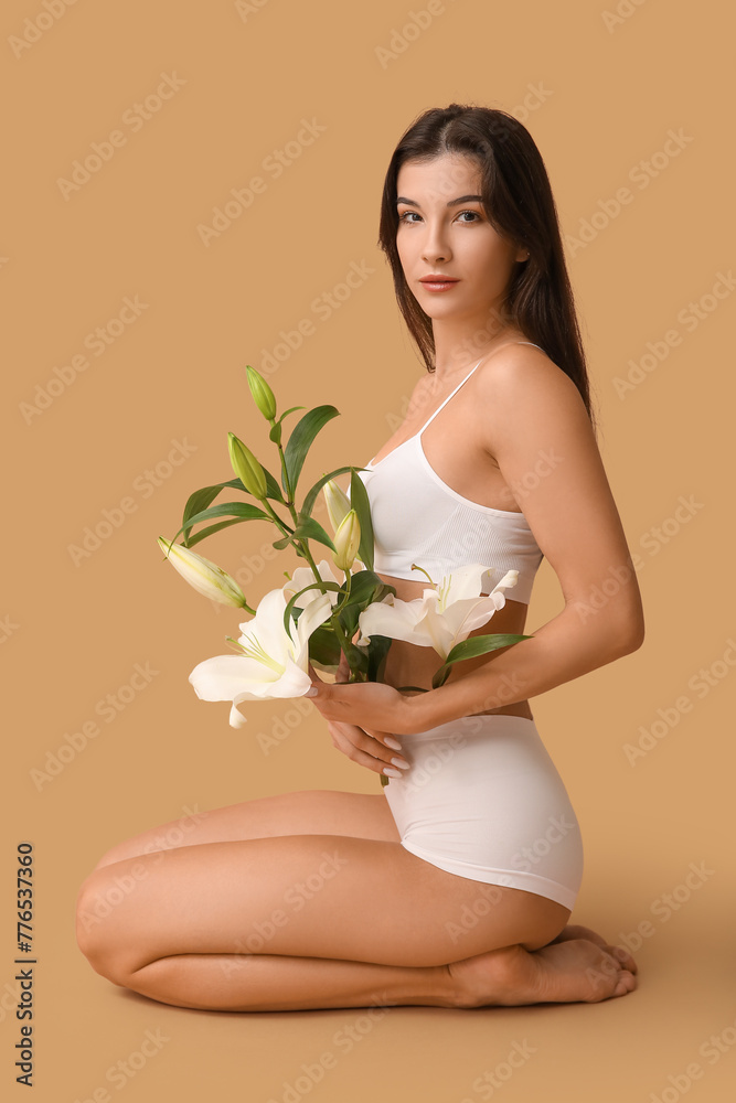 Beautiful young woman with white lily flowers sitting on color background Beautiful young woman with white lily flowers sitting on color background