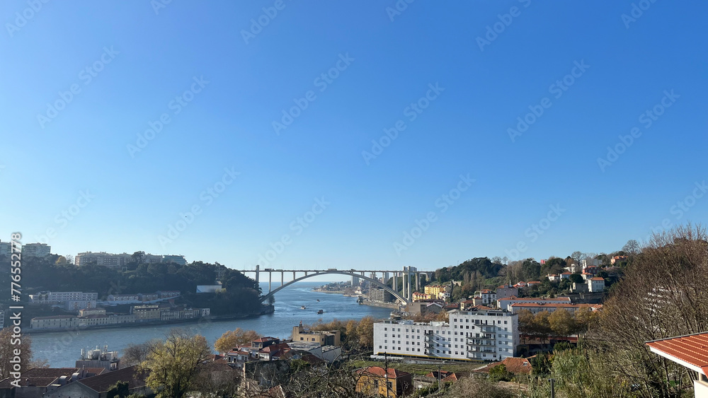 Porto, a coastal city in northwest Portugal, renowned for its imposing bridges and production of Port wine. Image showcases the Douro River and Porto cityscape.