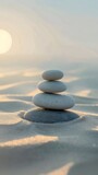 Stack of rocks sits atop a sandy beach, minimalist and abstract scene against the backdrop of the soft sand