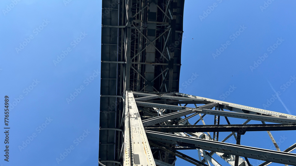 A monumental iron structure, spanning the river in Porto, symbolizing engineering prowess and the city's historic connection.
Iconic Dom Luís I Bridge in Porto, Portugal: A stunning iron arch bridge 
 - obrazy, fototapety, plakaty 
