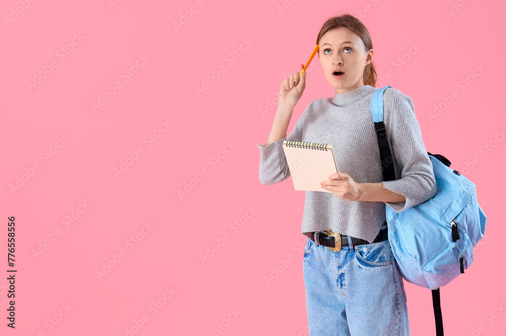 Female student with notebook trying to remember something on pink background. End of school concept Female student with notebook trying to remember something on pink background. End of school concept
