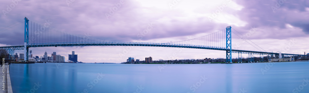 Naklejka premium The Ambassador Bridge across the Detroit River connecting Detroit, Michigan in the United States with Windsor, Ontario in Canada, a panoramic long-exposure photography