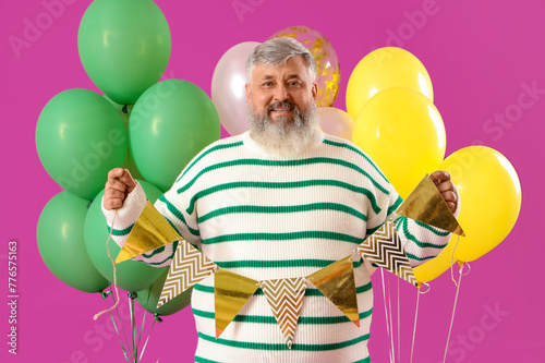 Senior man with bunches of ...
