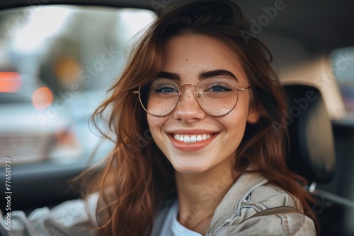 Happy woman smiling in car driving