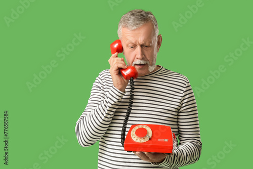 Shocked senior man talking ...