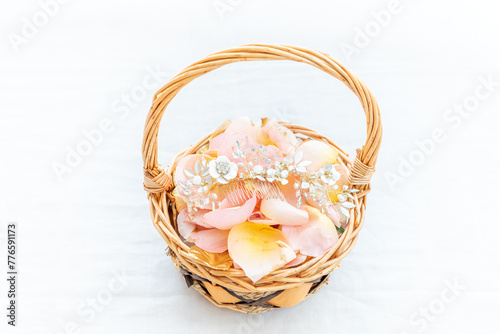 Petals and wedding jewellery in a basket