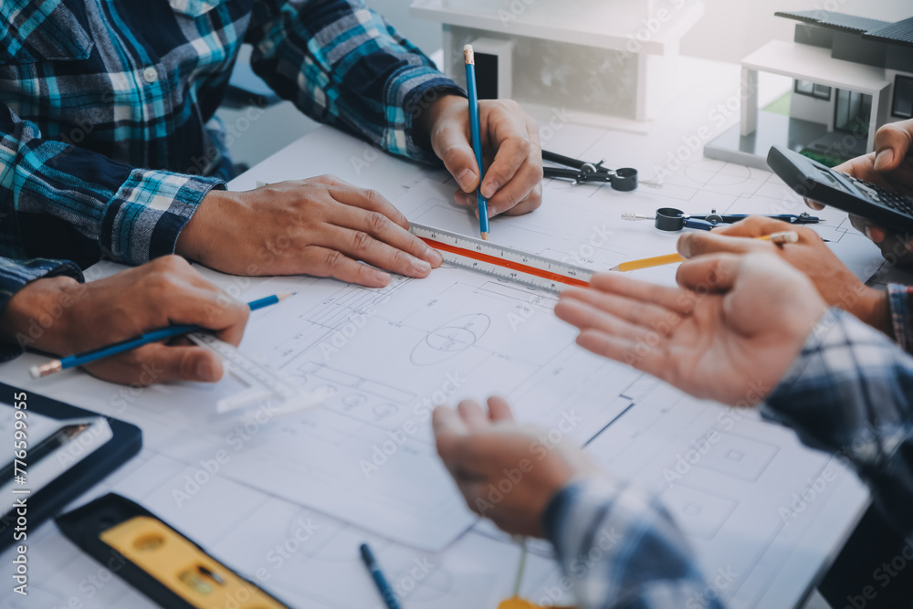 engineer people meeting working and pointing at a drawings in office for discussing. Engineering tools and construction concept. engineer people meeting working and pointing at a drawings in office for discussing. Engineering tools and construction concept.