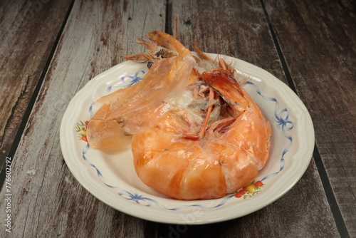 fried shrimps on a plate. Baked large tiger prawn. Famous steamed seafood menu in Asian restaurant.