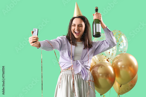 Drunk young woman with champagne taking selfie after Birthday party on green ...