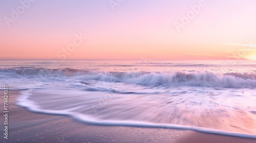 The serene beauty of a calm ocean at sunrise, where gentle waves whisper to the shore under a sky painted in soft hues of pink and orange.