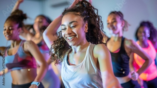 Depict a spirited dance fitness class where young sportswomen immerse themselves in the rhythm and energy of the music, celebrating the joy of movement and the fusion of exercise and dance.
