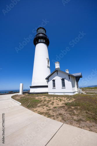 Yaquina Head Lighthouse against blue sky, along Pacific coast in Oregon, USA. photo