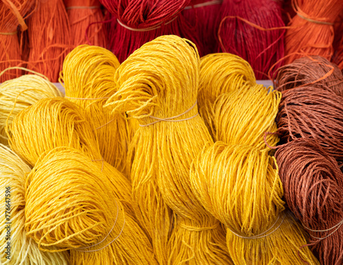 Colorful bunches of threads in a warm color palette at an outdoor baazar in Izmir, Turkey