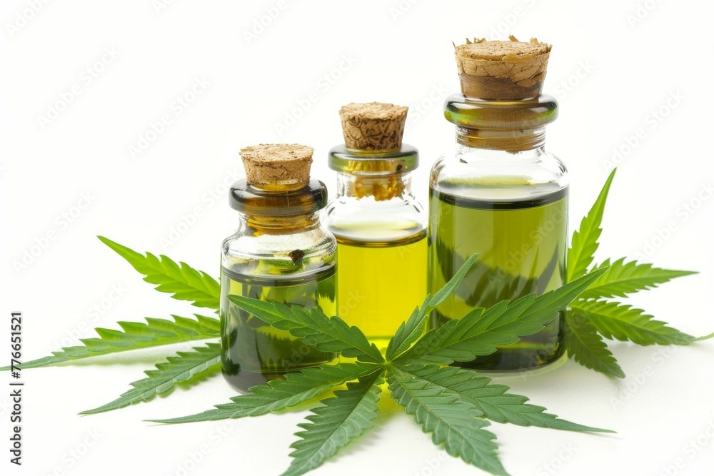 Three bottles of cannabis oil are displayed on a white background Three bottles of cannabis oil are displayed on a white background