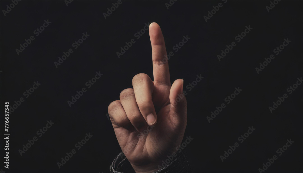 Hand with index finger raised, foremost, male, right hand, suggestion, black background, close-up Hand with index finger raised, foremost, male, right hand, suggestion, black background, close-up