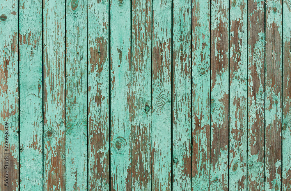 Texture of old weathered green plank fence with peeling paint Texture of old weathered green plank fence with peeling paint