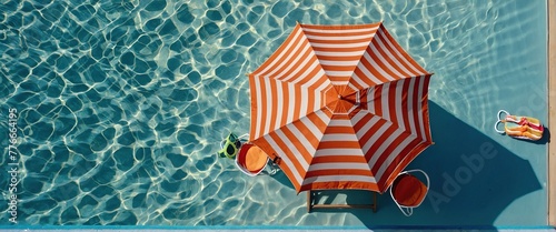 Top view Beach umbrella with chairs and beach accessories on blue background, summer vacation concept photo