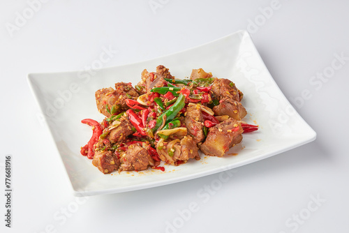 Stir-fried stewed beef shank with holy basil , chili and garlic served on white plate isolated on white background. Stir-fried holy basil is a very popular food in Thailand.