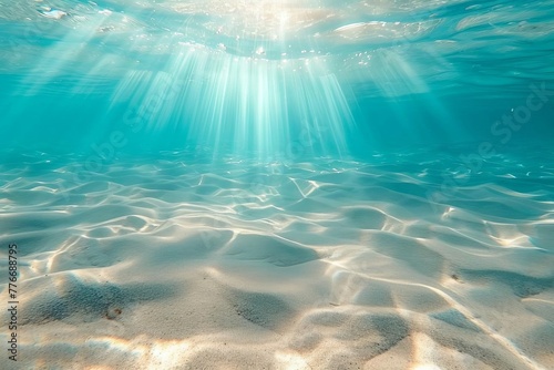 Tranquil underwater scene with sandy seabed and sunlight filtering through crystal clear water, abstract ocean background