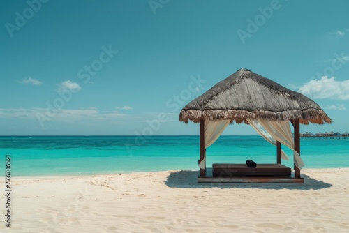 Beach cabana with thatched roof against a turquoise sea backdrop