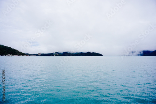 Sun Moon Lake，Nantou, Taiwan, Republic of China, 01 22 2024: The landscape of Sun Moon Lake (Ri Yue pond) in a cloudy and foggy day photo