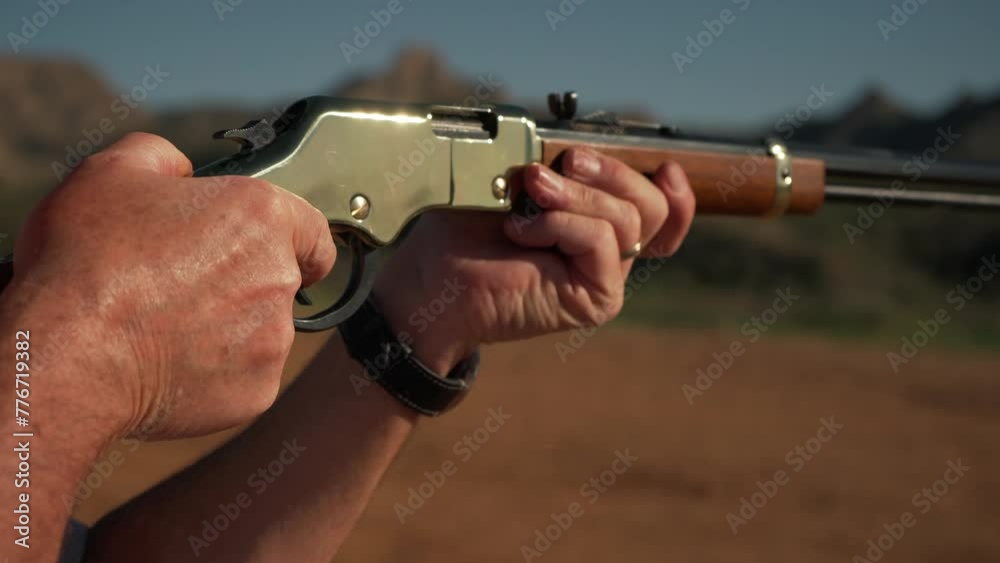 A man shooting a classic lever action rifle