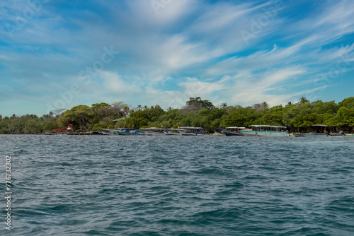 Boat on the seashore and stone spur. San Bernardo, Bolivar, Colombia. 