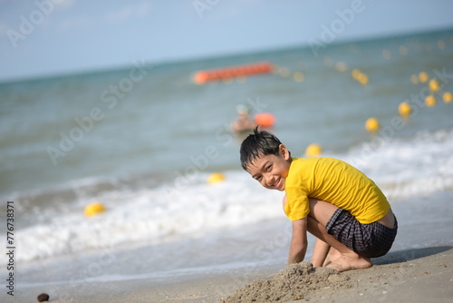 Child and person enjoying beach fun by the sea, playing and fishing in the sand on a sunny summer day