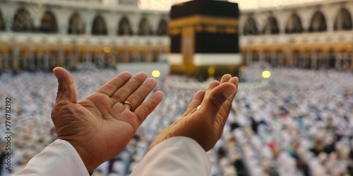 Muslim Man hand praying up in front of Kaaba at the Mecca.  photo
