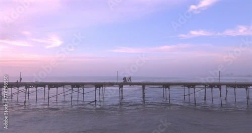 Aerial view of beauty sunset over the sea and dock with artisanal fishermen. Puerto Eten, Peru. 
