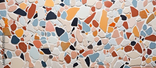 Vibrant and diverse tiles create a colorful wall, contrasting against a sleek black toilet in a modern bathroom setting