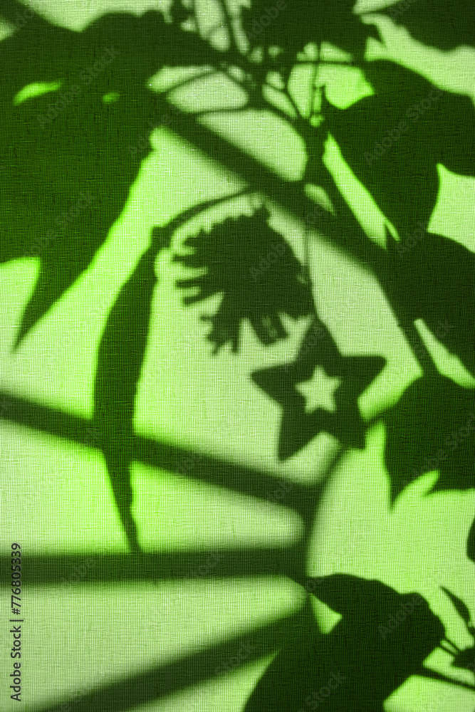 Fototapeta premium Light and shadows on fabric texture. Vintage textile background. Abstract backdrop with floral pattern and crossed lines shadows.