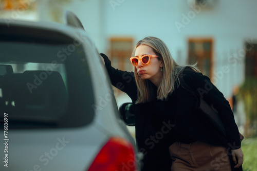 Woman Locked Out of her Car Looking Inside Confused. Stressed driver not being able to enter her own auto
 photo