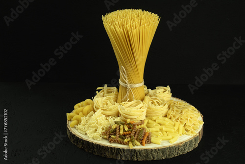Dry pasta on a wooden surface. The process of making pasta