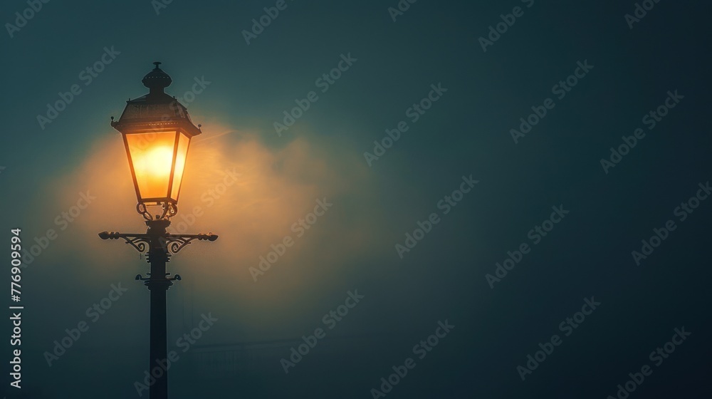 An old-fashioned street lamp glows softly, its light cutting through the thick fog of a quiet, mysterious night.