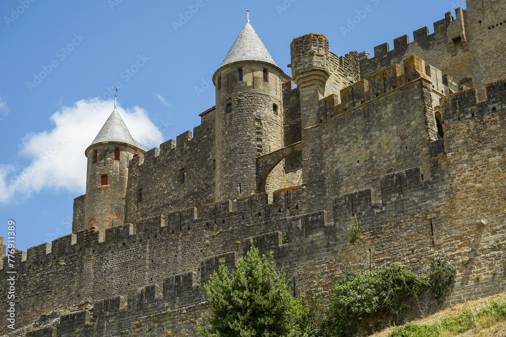 Carcassonne hillltop medieval citadel castle with watchtowers and fortification close-up view, popular tourist destination, France